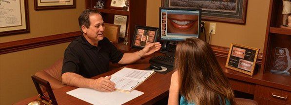 Lawrenceville dentist talking to patient at desk