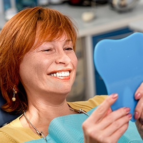 red haired woman smiling in mirror