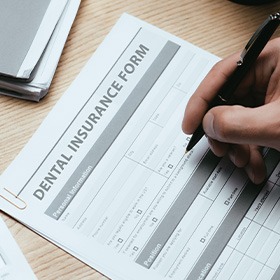 a patient filling out a dental insurance form