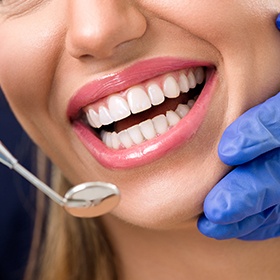 close shot of womans smile and mirror