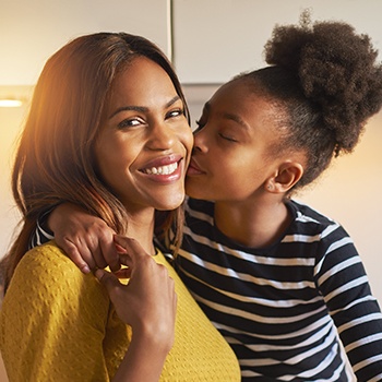 daughter kissing mother