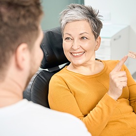 a patient speaking with her dentist about dentures