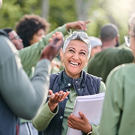 a person smiling and chatting with others