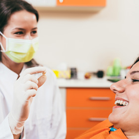 a patient smiling after having her tooth extracted