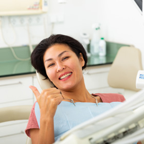 a patient smiling while visiting the dentist