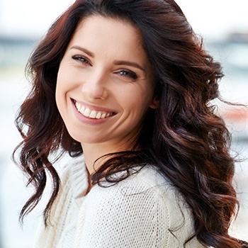 woman with curly hair smiling