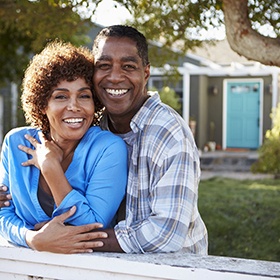 couple smiling on their front porch 