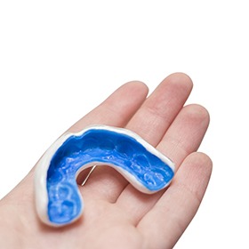 Close-up of hand holding an athletic mouthguard