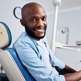 Male dental patient smiling while waiting for dentist