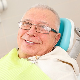 older man with glasses smiling