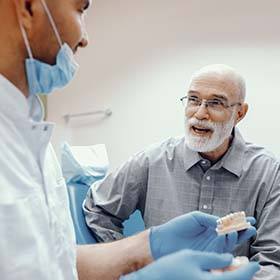 senior man asking his dentist questions about dental implants