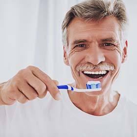 senior man brushing his teeth