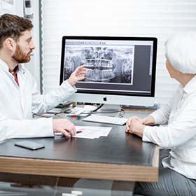 dentist showing a patient their X-rays