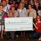 Lawrenceville dental team holding giant check at event