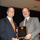 Lawrenceville dentists in suits holding plaque award