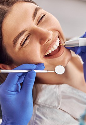 a woman getting a dental checkup and cleaning near Allendale