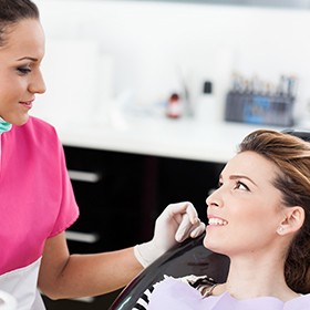 woman smiling at assistant in pink