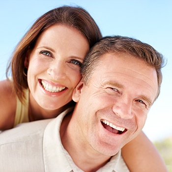 man giving wife piggback ride