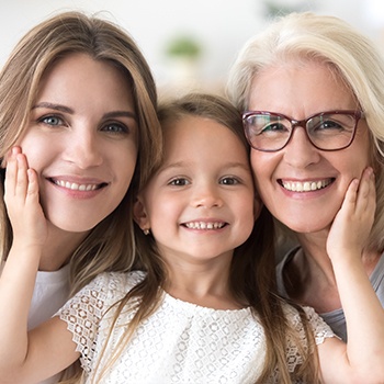 grandmother, mother, and daughter smiling