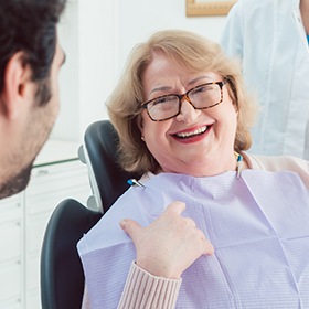 woman in exam chair laughing