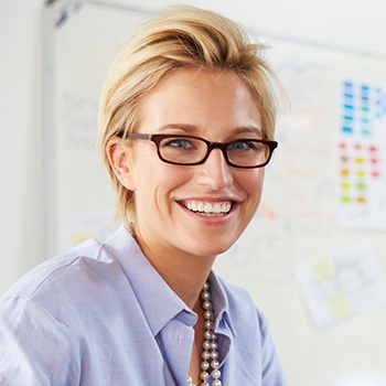 woman with glasses smiling