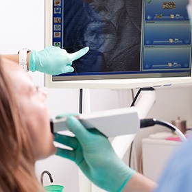 doctor pointing to intraoral camera