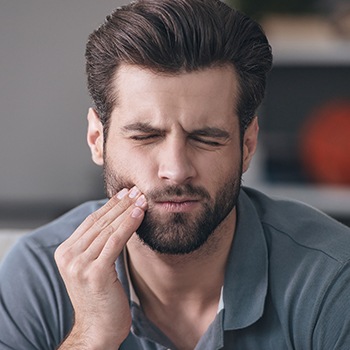 handsome man closing eyes in pain