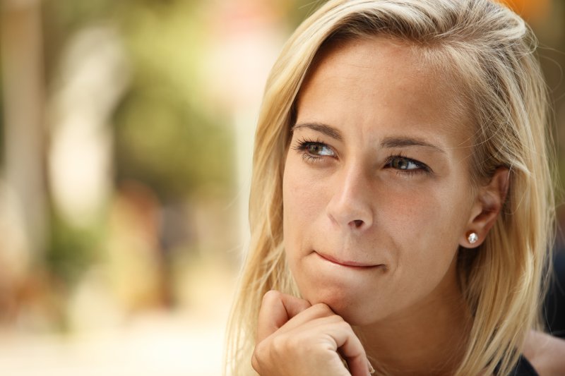 woman with blonde hair thinking