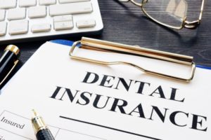 Lawrenceville dentist goes over dental insurance on clipboard
