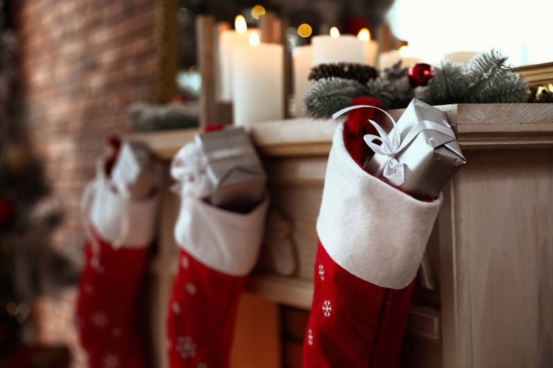 Stockings filled with gifts on fireplace