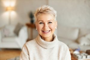Woman wearing a beige sweater smiling