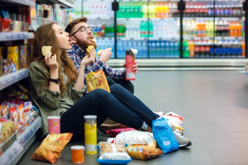 Couple snacking at grocery store