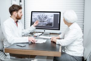 woman learning about dental implants in Lawrenceville