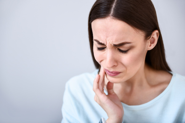 woman grimacing with a toothache