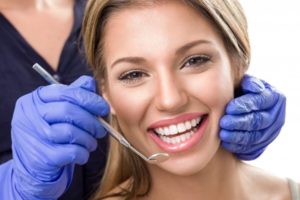 a patient smiling during her dental checkup