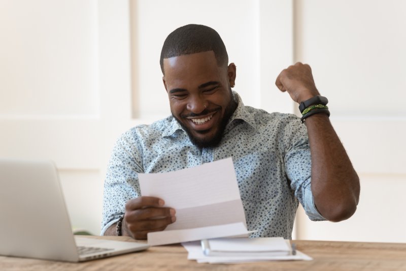 man looking at a piece of paper and getting psyched