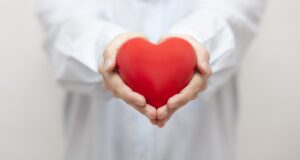 Red heart cupped in hands