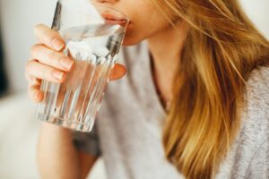 Woman sipping a glass of water